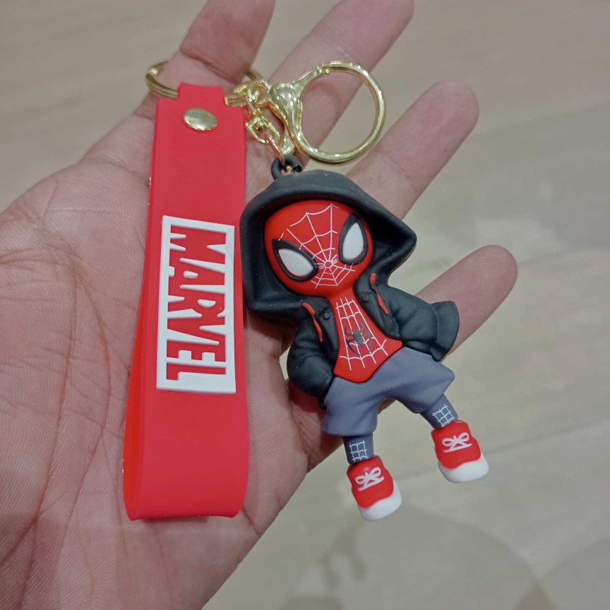 Rubber keychain featuring a hooded superhero figure design