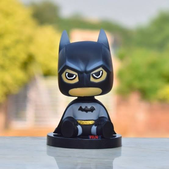 Bobblehead figure with nodding head displayed on desk