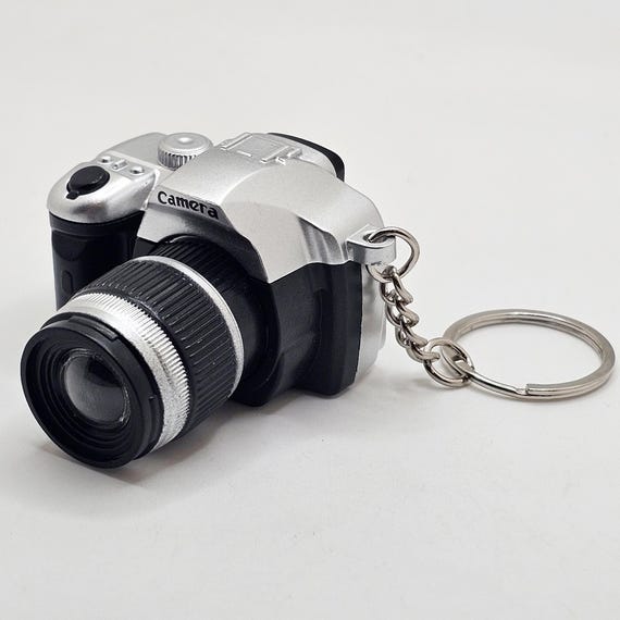 Mini camera keychain shaped like a DSLR camera with flash and sound feature